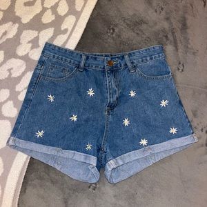 I am selling high waisted denim shorts that have an embroidered flower print.